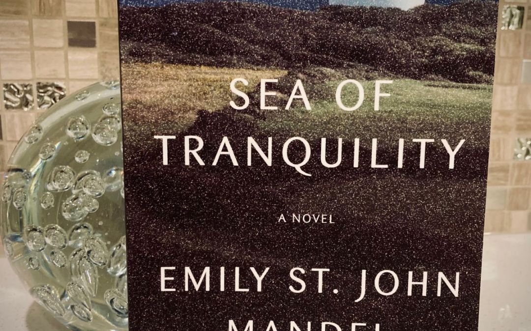 Sea of Tranquility by Emily St. John Mandel book with a glass orb behind it