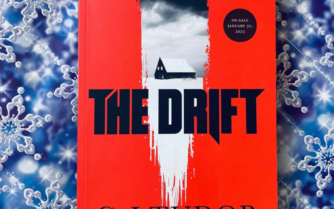 The Drift by C.J. Tudor book pictured on a blue background with snowflakes