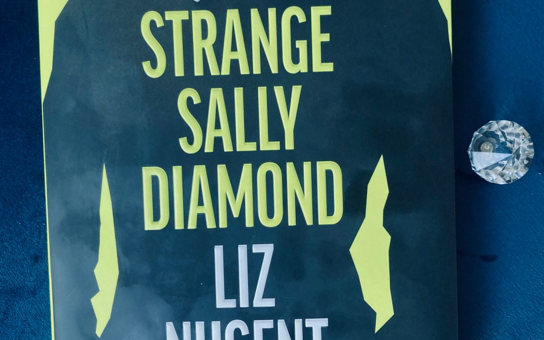 Strange Sally Diamond by Liz Nugent book pictured beside a small clear crystal