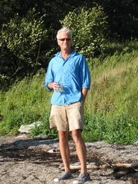 I found this photo of him on the internet, he's not physically on a boat but looks like he just stepped off one