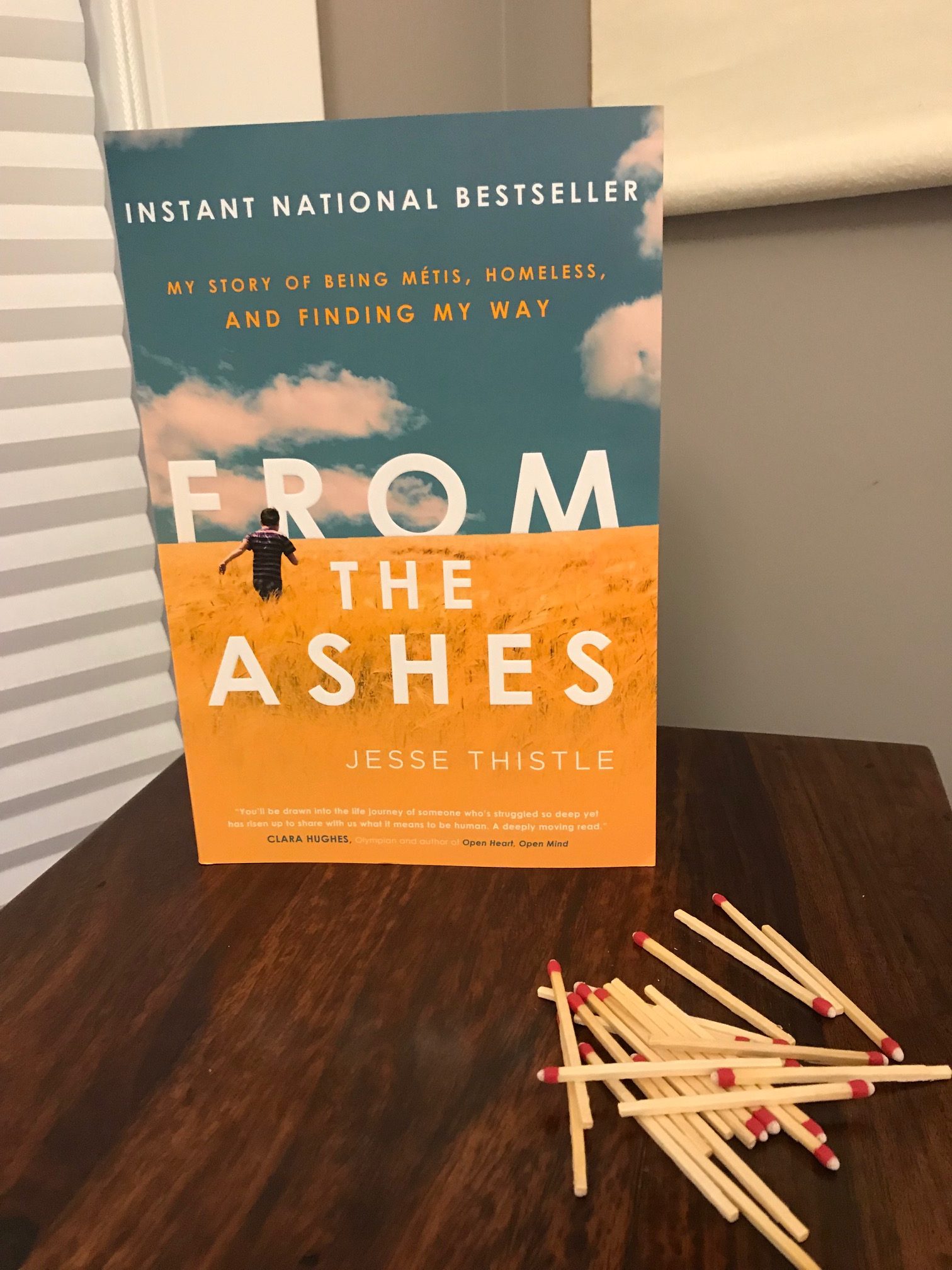 Picture of From the Ashes by Jesse Thistle book, with scattered matches around the base of the book