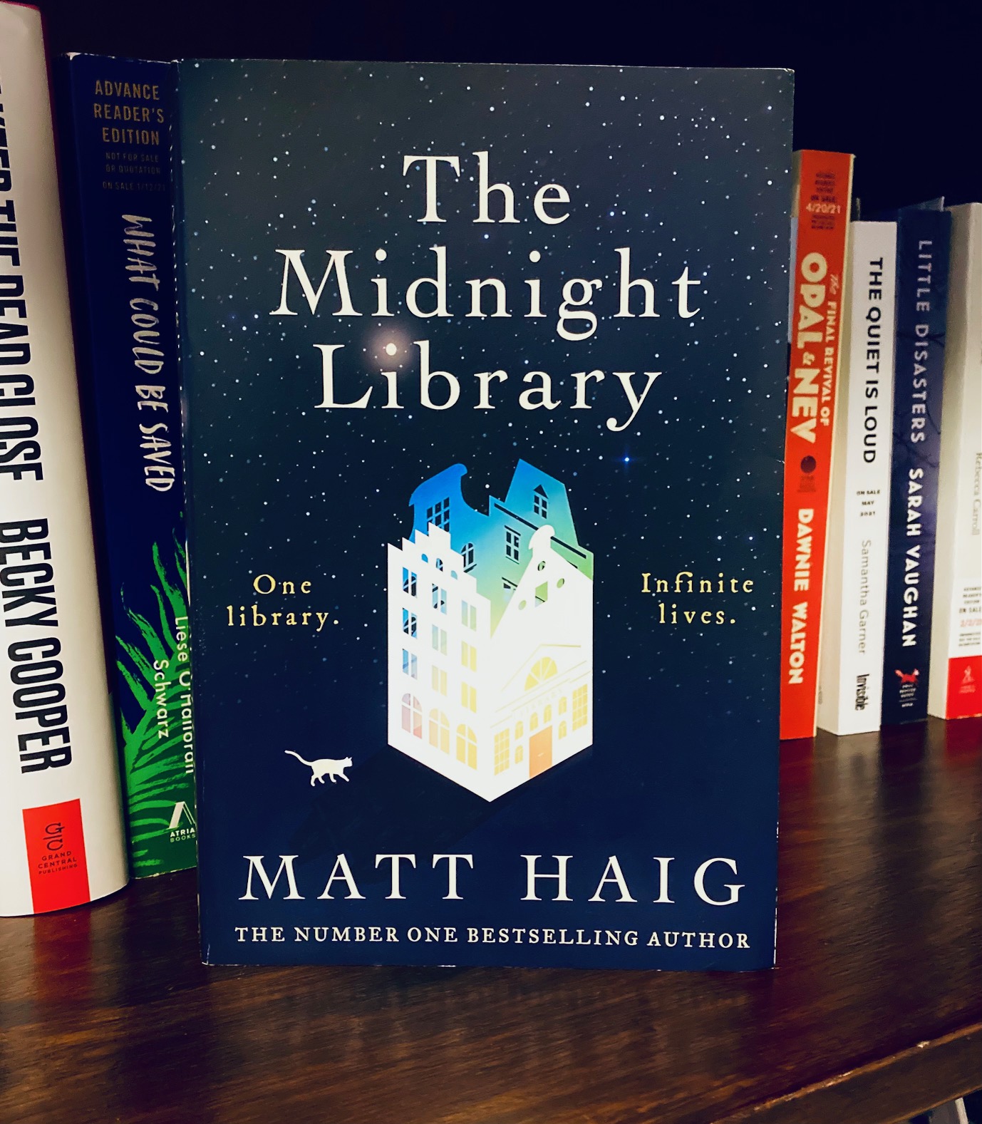 The Midnight Library by Matt Haig book, pictured on a wooden bookshelf in front of other books