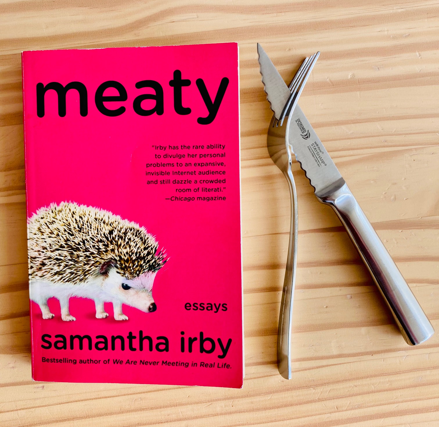 Meaty by Samantha Irby book pictured beside a knife and fork