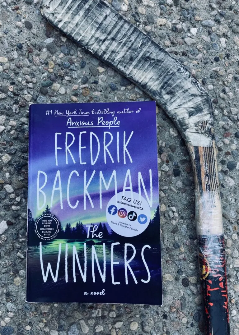 picture of The Winners book by Fredrik Backman, on a stone background with a dirty hockey stick