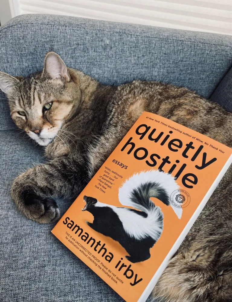 Quietly Hostile by Samantha Irby book pictured beside a brown tabby cat