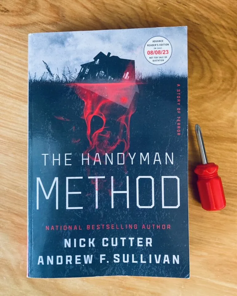 The Handyman Method by Nick Cutter and Andrew F. Sullivan book pictured beside a small red screwdriver