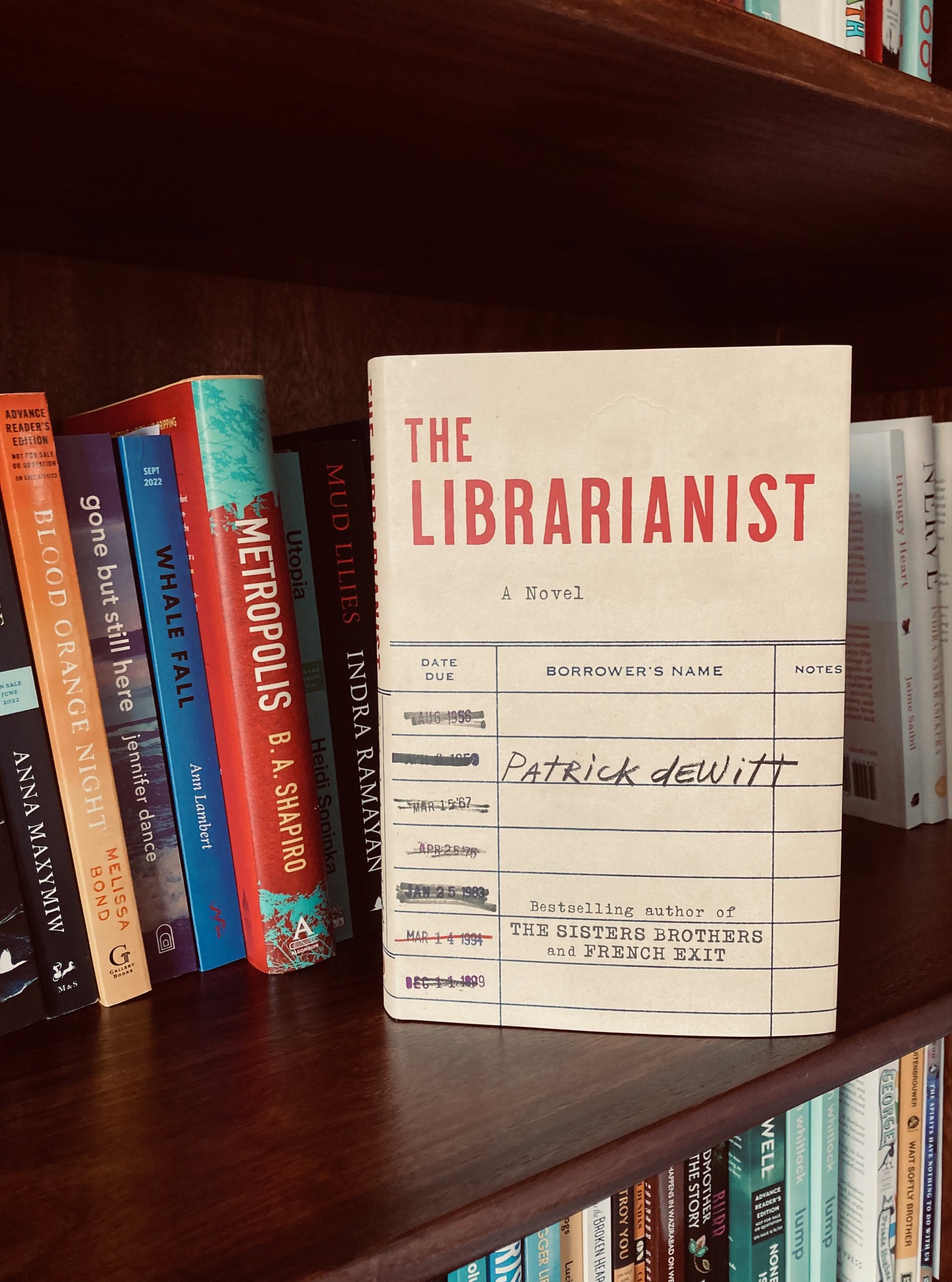 The Librarianist by Patrick deWitt book pictured on a book shelf in front of other books