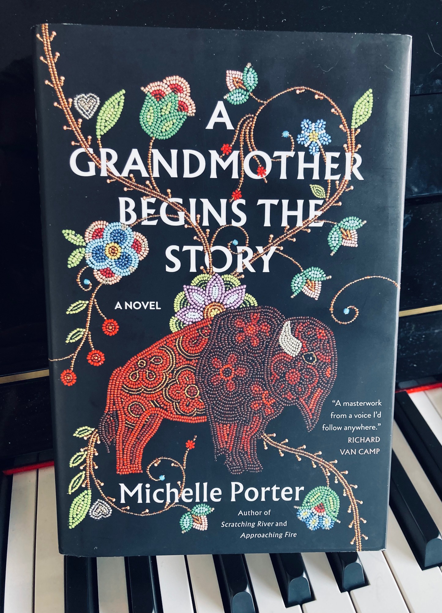 A Grandmother Begins the Story by Michelle Porter book pictured on the keys of a piano