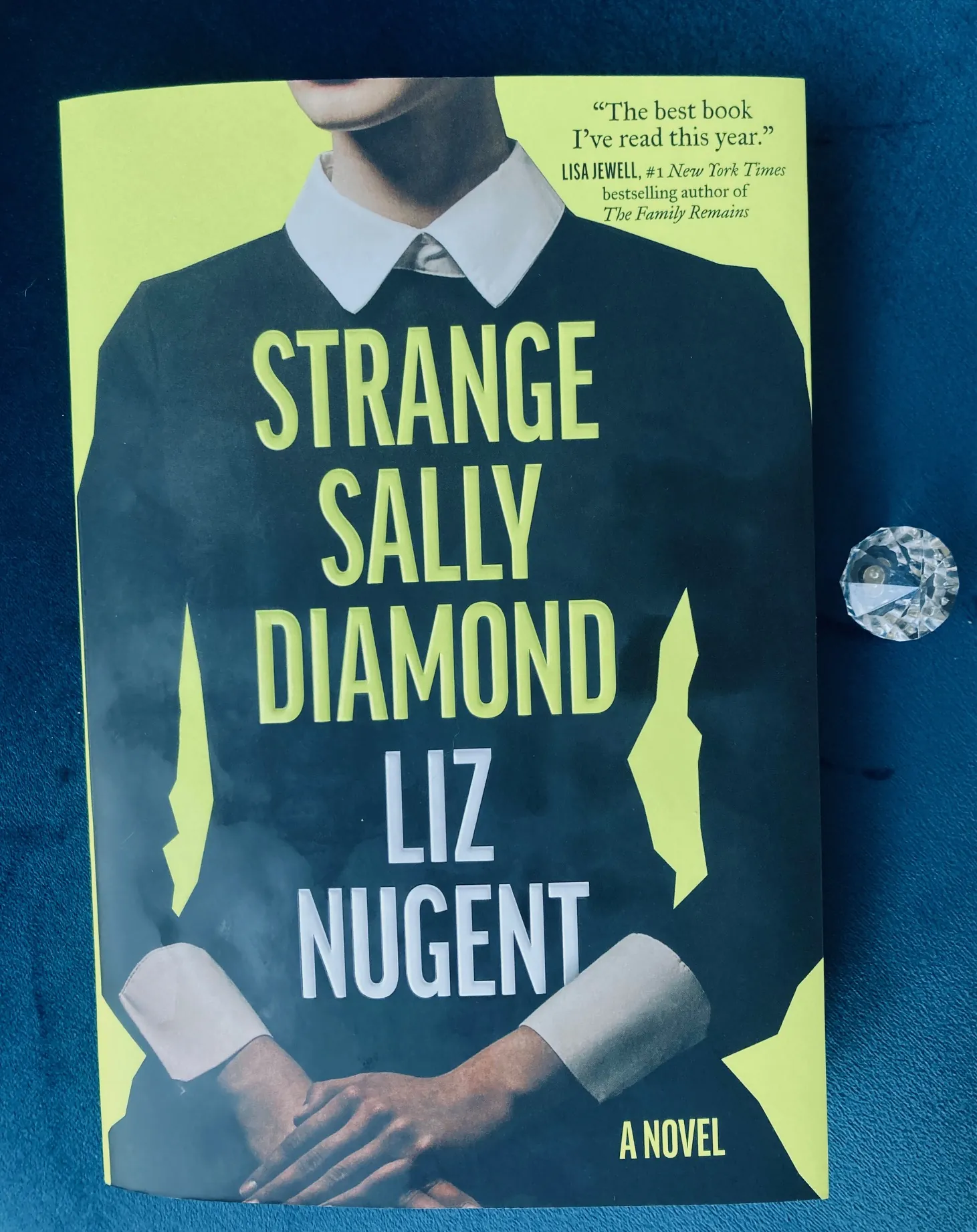 Strange Sally Diamond by Liz Nugent book pictured beside a small clear crystal