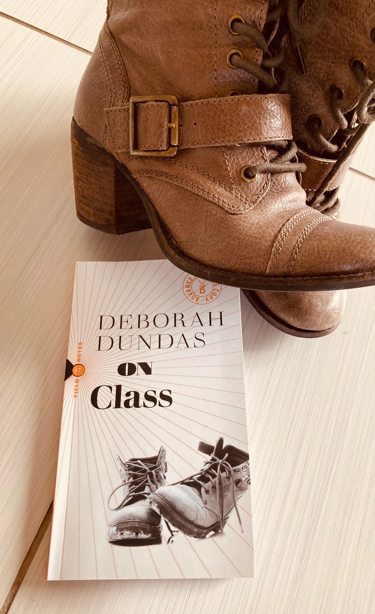On Class by Deborah Dundas book pictured beside two brown boots